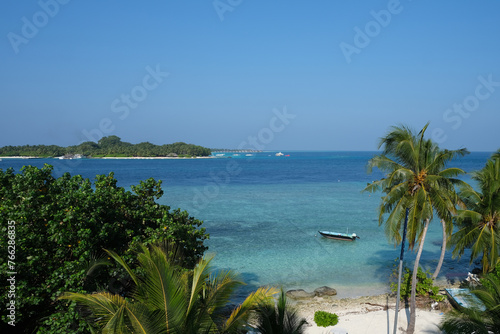 Beautiful afternoon beach scene of Rasdhoo. It is an inhabited island of the Maldives. The beach scene with boat floating on it.