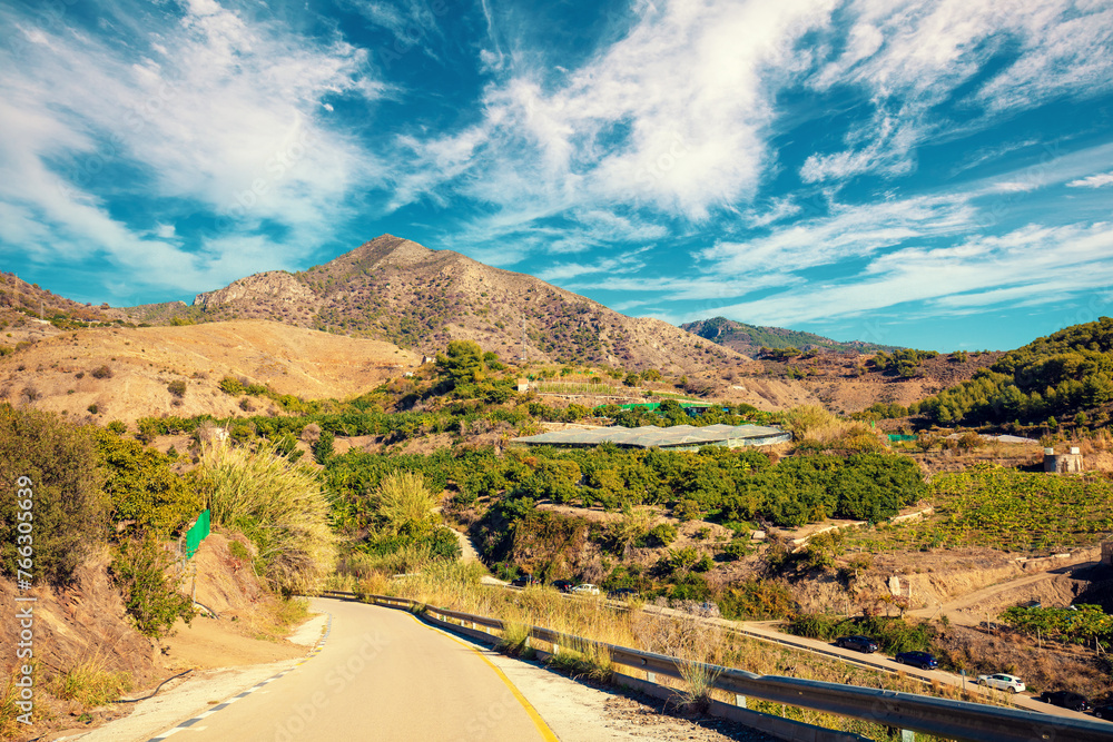 Southern region of Spain. Country road in the mountains. Agriculture greenhouses on the mountain slopes. Descent to Maro beach. Maro, Nerja, Spain