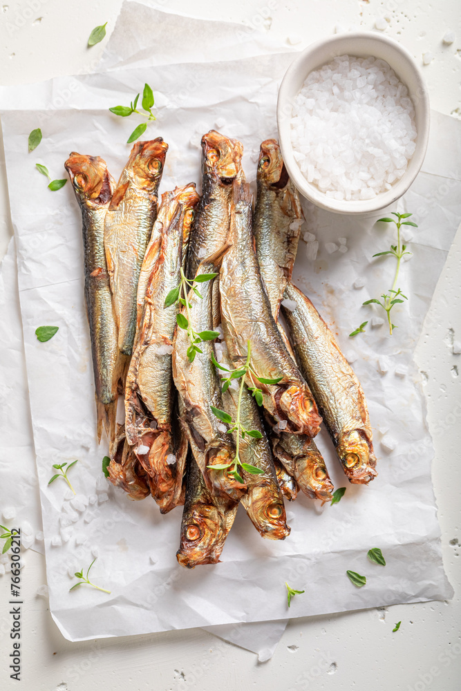Healthy and fresh smoked sprats marinated with salt and spices. Healthy and fresh smoked sprats marinated with salt and spices.