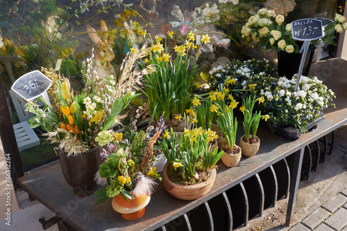 Beautiful spring flowers in front of flower shop on a spring day. Easter floral arrangements.