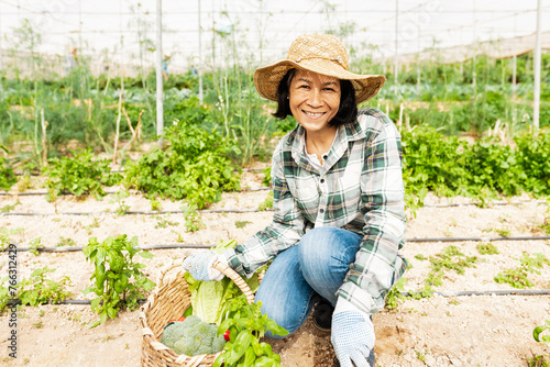 Happy southeast Asian woman working inside agricultural greenhouse - Farm people lifestyle concept