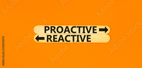 Proactive and reactive symbol. Concept word Proactive Reactive on beautiful wooden stick. Beautiful orange table orange background. Business proactive and reactive concept. Copy space.