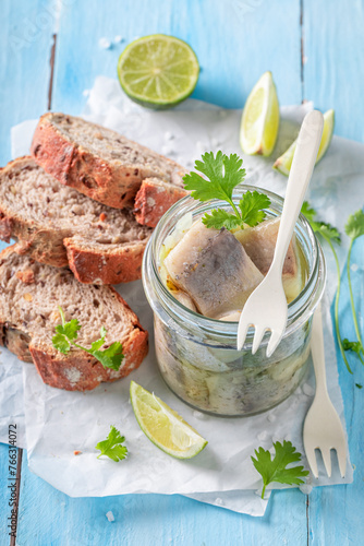 Healthy and tasty marinated herring in oil, herbs and onions.