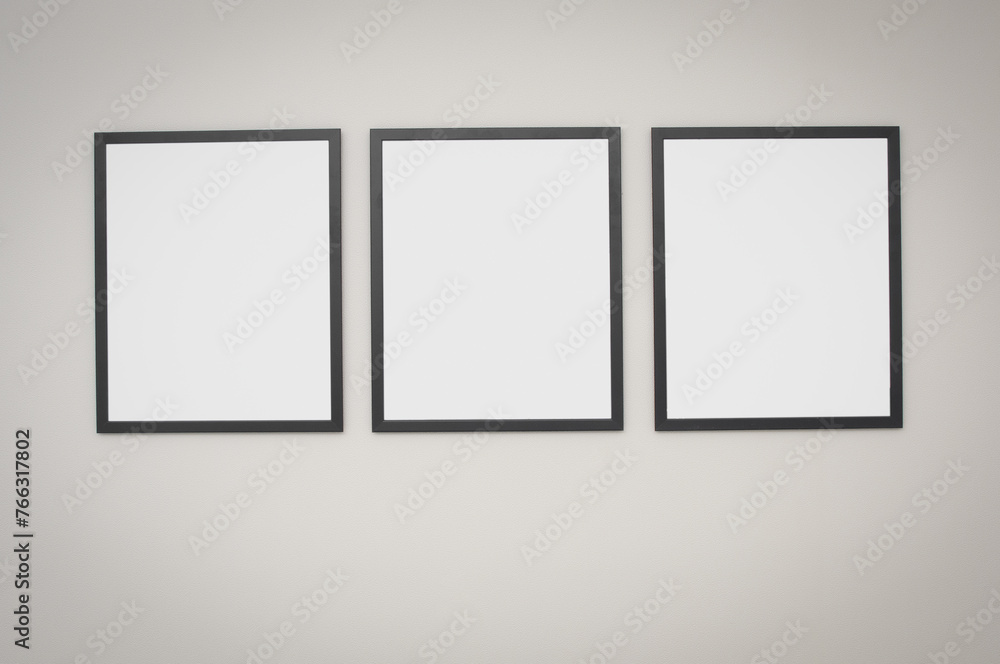 Three blank frame on a gray wall Three blank frame on a gray wall