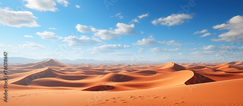 Desert sand dunes and blue sky photo