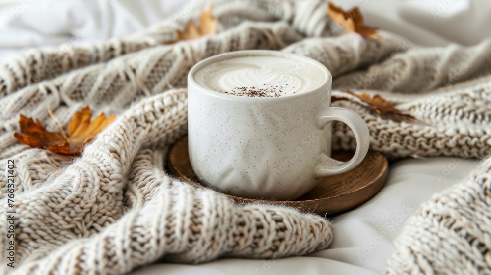 Hot Cappuccino on Knitted Sweater with Autumn Leaves Hot Cappuccino on Knitted Sweater with Autumn Leaves