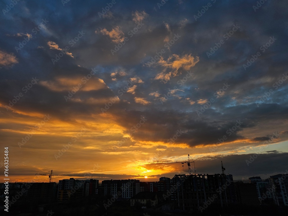 Beautiful sunset over the city. Colored clouds at sunset. Sunset over city