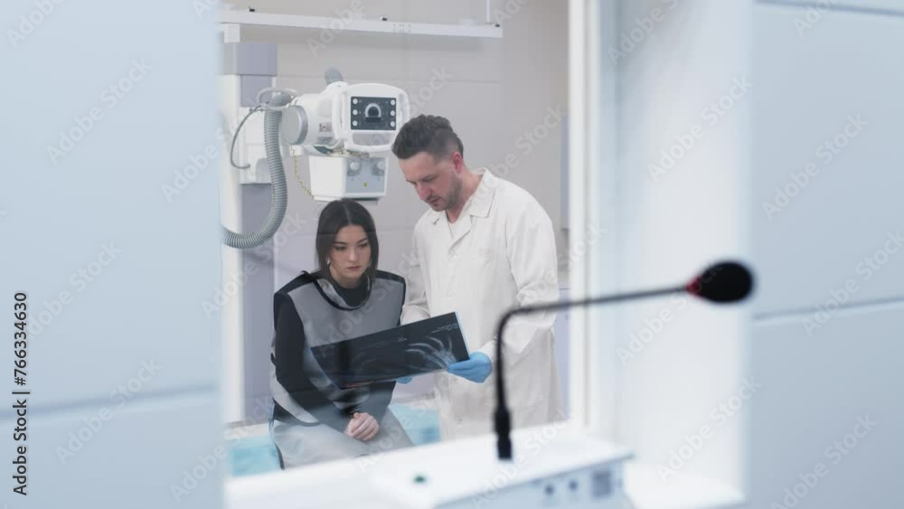 Patient consultation in a modern clinic against the background of x-ray equipment. Medical consultation, modern medical technologies. Patient consultation in a modern clinic against the background of x-ray equipment. Medical consultation, modern medical technologies.