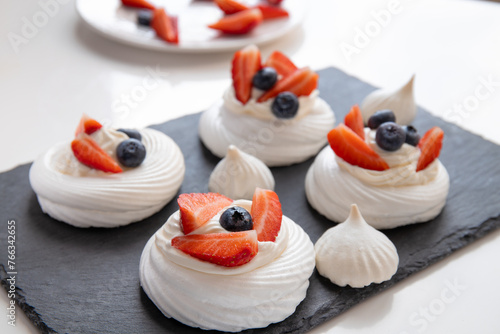 Pavlova dessert with fresh berries. Meringue (beze) with strawberries and blueberries. 
