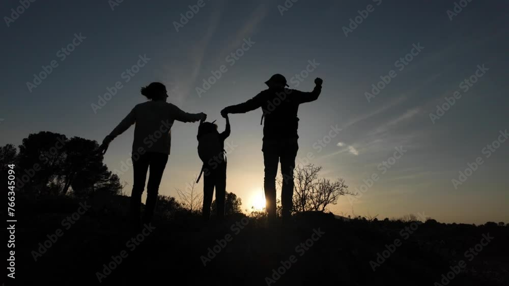 Mother father help children in mountain silhouette sunset concept grow help education i achievements in life with family i care Mother father help children in mountain silhouette sunset concept grow help education i achievements in life with family i care