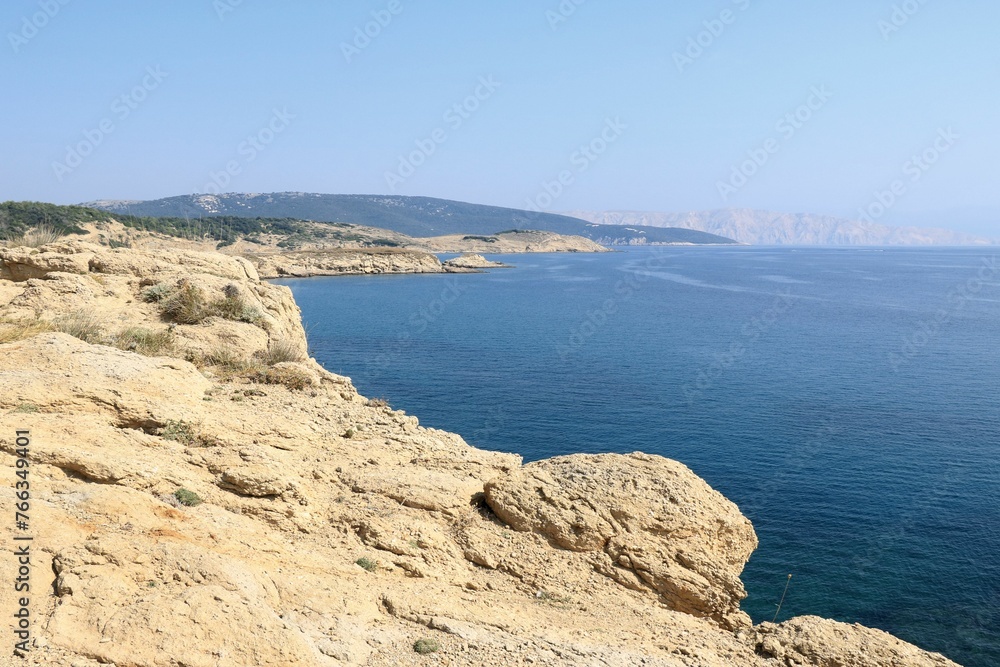 The blue sea and sandstone coast of Lopar on the island Rab, Croatia