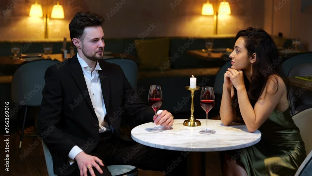 Beautiful loving young couple spending time together in modern restaurant while talking. Lifestyle, love, relationships concept. Slow motion Beautiful loving young couple spending time together in modern restaurant while talking. Lifestyle, love, relationships concept. Slow motion