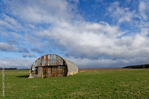 The one and only remaining small Aircraft Hanger now used for Farm storage set in the level farmland of the old Wartime Stracathro Airfield.