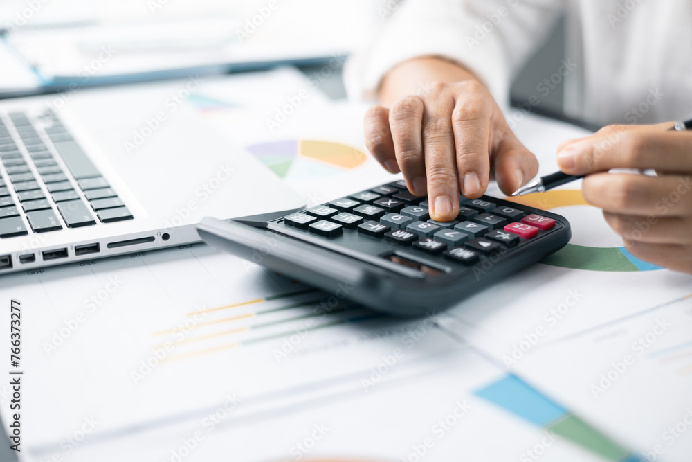 Businesswoman hand doing finances and calculate on desk about cost at home office. Business financing accounting banking concept. Woman working on desk with using calculator, finance accounting. Businesswoman hand doing finances and calculate on desk about cost at home office. Business financing accounting banking concept. Woman working on desk with using calculator, finance accounting.