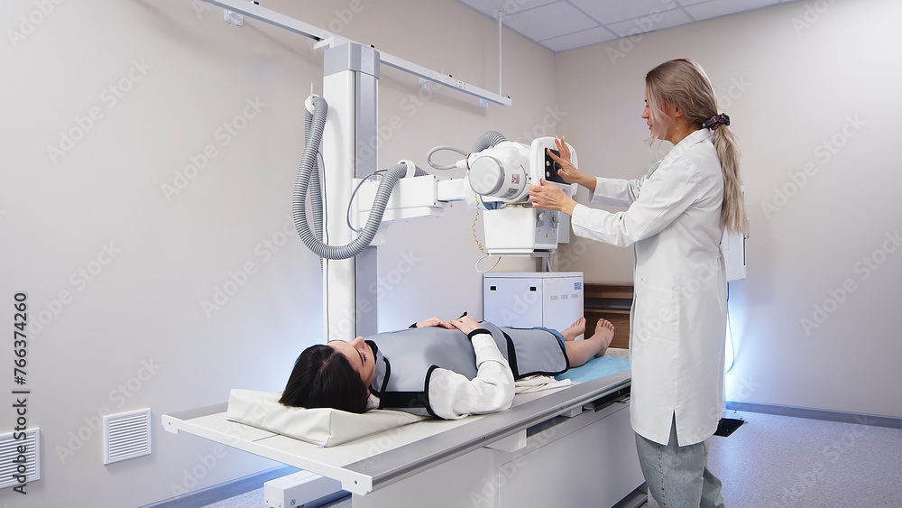A specialist radiologist doctor installs an x-ray scanner for a patient. Medical research, injury and treatment concept. A specialist radiologist doctor installs an x-ray scanner for a patient. Medical research, injury and treatment concept.