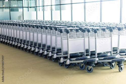 Many empty luggage trolleys at the airport.