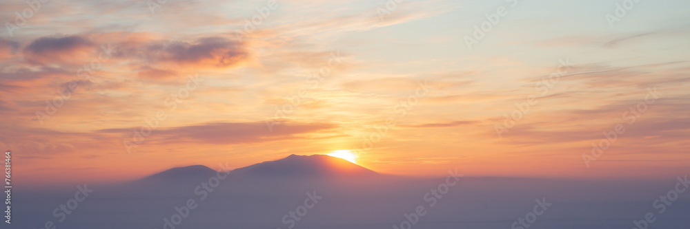 Winter arctic landscape. Cold winter weather. Frosty fog over the winter tundra. Sunset over the tundra and snow-capped mountains. The nature of Chukotka and polar Siberia. Far North of Russia, Arctic - obrazy, fototapety, plakaty 