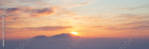 Winter arctic landscape. Cold winter weather. Frosty fog over the winter tundra. Sunset over the tundra and snow-capped mountains. The nature of Chukotka and polar Siberia. Far North of Russia, Arctic