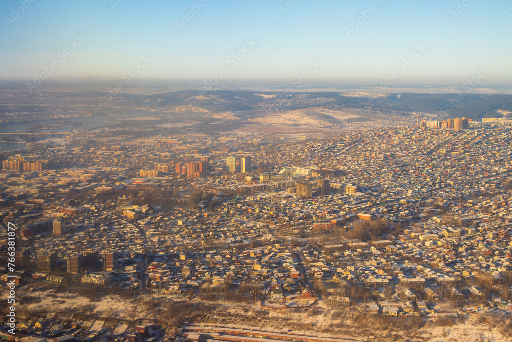 Top view of the city of Irkutsk, Irkutsk region, Siberia, Russia. Aerial photograph of low-rise buildings on the outskirts of a large Siberian city. View from above of buildings and city streets.