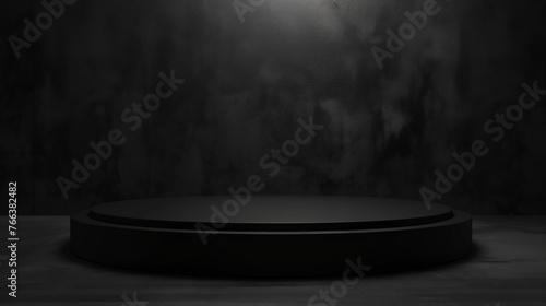  A mockup of a black round display plinth in front of a black wall. Add your own item for display.