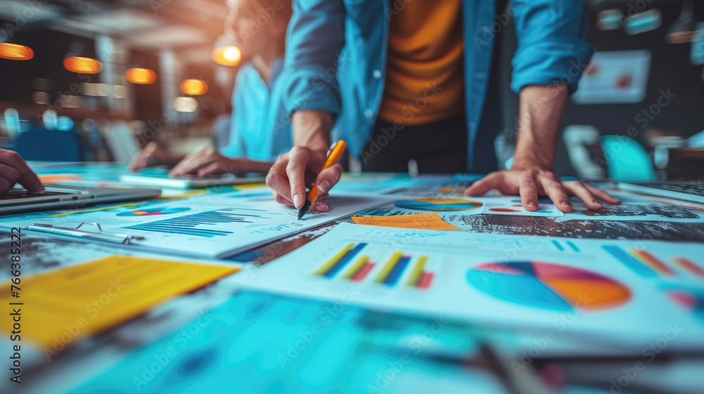 Fototapeta premium Businessman working on a table with many papers, the businessman wears a blue shirt and a yellow pen writes a goal report and transfers it to a profit graph. Ai generated