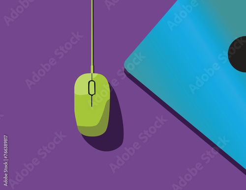 A green computer mouse sits on a desk near the blue laptop.