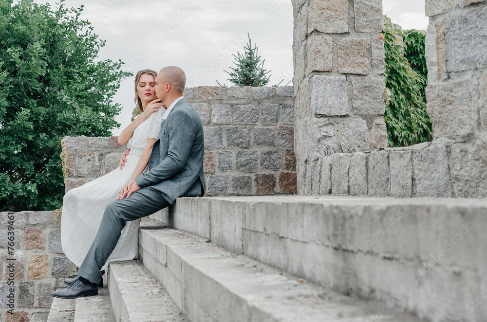 the bride and groom are sitting on the stairs the bride and groom are sitting on the stairs