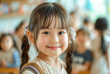 Asian girl in kindergarten, smiling schoolgirl in the classroom, preschool education, cheerful atmosphere.