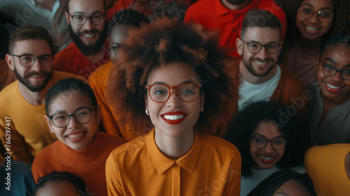 A diverse group of friends and family are posing for a photo, wearing casual clothing and smiling. DEI, DEIB