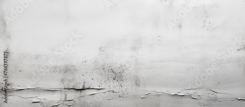 A black and white photo capturing a naturally textured grey wall covered in dirt, resembling a natural landscape in need of a cleansing fluid like water