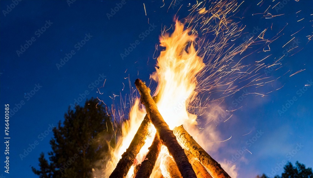Fototapeta premium Burning bonfire for Latvian traditional Ligo festival during midsummer. Fire in middle of the dusk in night at summers longest day and shortest night