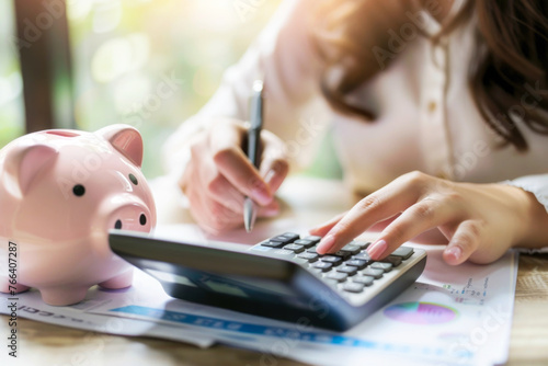 Women calculate expenses with calculator and piggy bank. Tax time, finance, investment and savings concept