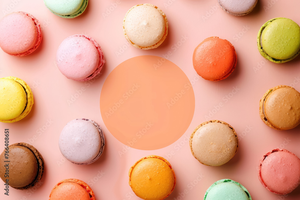 variety of macarons arranged around a peach colored circle on a soft pink background variety of macarons arranged around a peach colored circle on a soft pink background