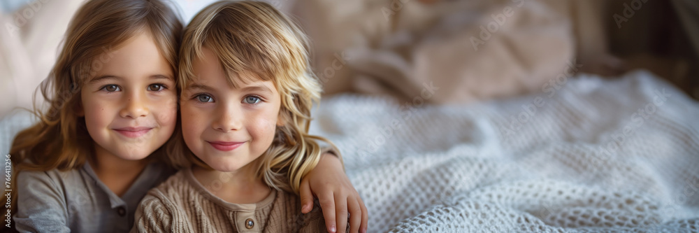 Portrait of two young Caucasian siblings with gentle smiles, embracing on a cozy knitted blanket, conveying family warmth and childhood innocence Portrait of two young Caucasian siblings with gentle smiles, embracing on a cozy knitted blanket, conveying family warmth and childhood innocence