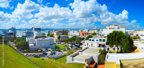 Old San Juan historic district skyline, vibrant landmark buildings and houses, and dramatic tropical cloudscape in Puerto Rico photo