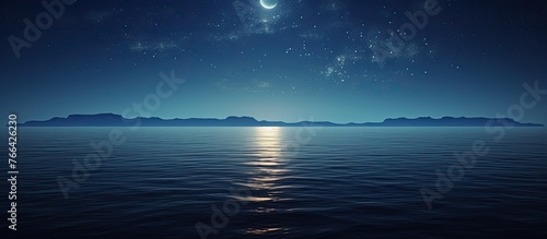 Serene night view with the glowing moon and stars casting a shimmering reflection on the tranquil ocean surface