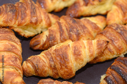 Close up of pile of delicious croissants on a dark background. Homemade croissants.