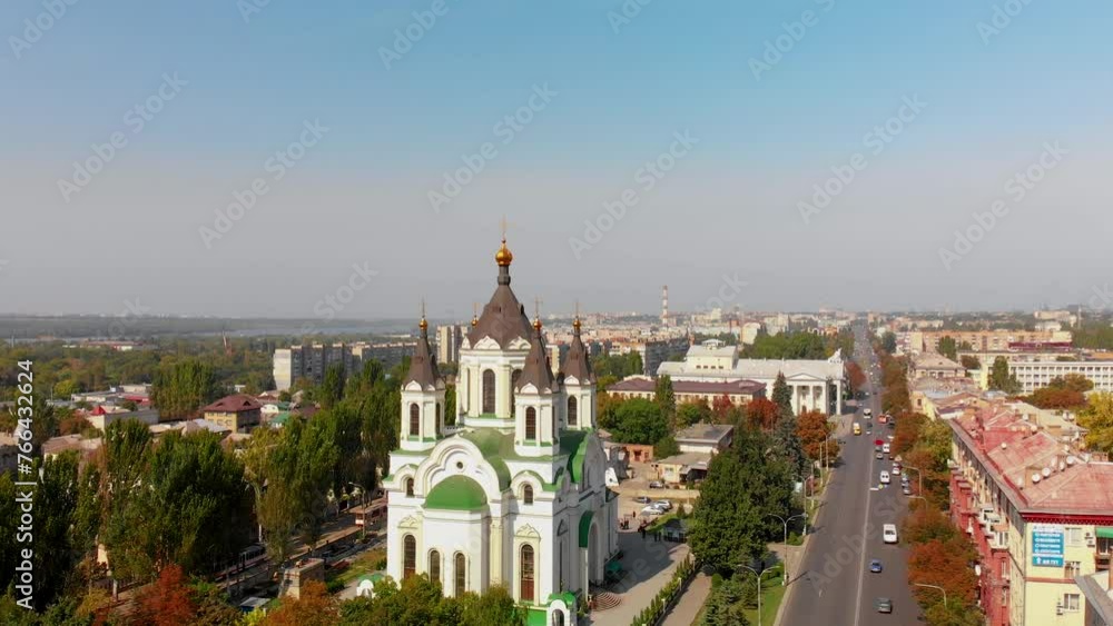 Beautiful aerial view of the city of Zaporozhye in Ukraine and the Orthodox Cathedral. Streets along which vehicles travel. The roofs of houses. Pipes of factories and factories in the background. Beautiful aerial view of the city of Zaporozhye in Ukraine and the Orthodox Cathedral. Streets along which vehicles travel. The roofs of houses. Pipes of factories and factories in the background.