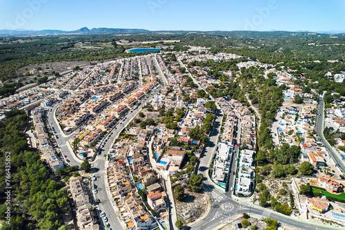Drone point of view countryside meadows and Pinar de Campoverde residential district view with modern new-built houses, villas view from above. Summer day. Costa Blanca, Province of Alicante, Spain
 photo