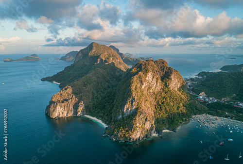 Fototapeta Naklejka Na Ścianę i Meble -  Aerial view of beach, sea and mountain on sunset. El Nido, Palawan. Tropical landscape hill, mountains rocks with rainforest and azure water of lagoon.