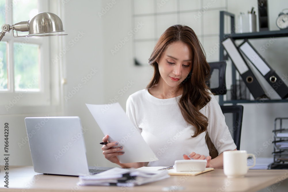 Confident female entrepreneur calculates and analyzes documents while working from home office. Confident female entrepreneur calculates and analyzes documents while working from home office.