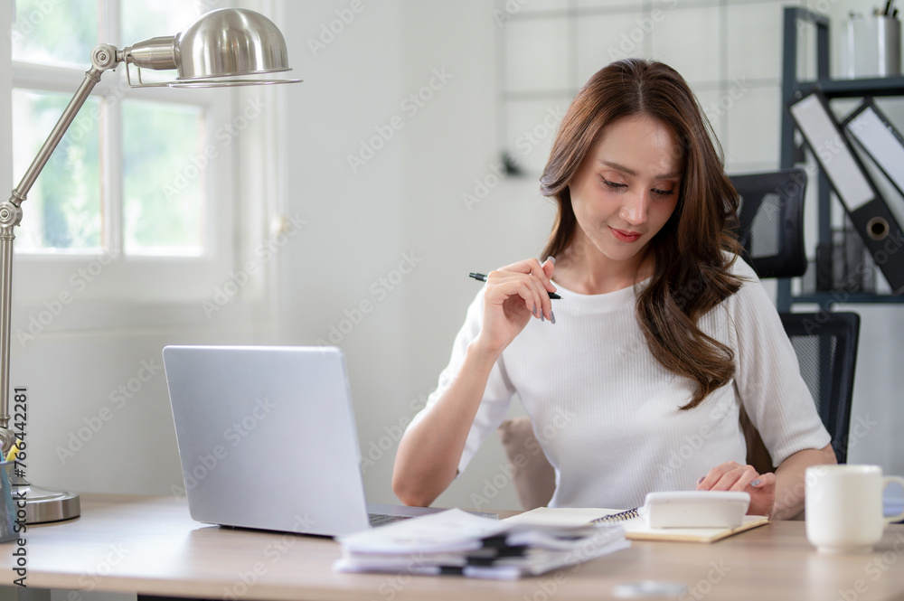 Confident female entrepreneur calculates and analyzes documents while working from home office. Confident female entrepreneur calculates and analyzes documents while working from home office.