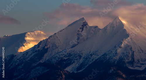 Mountains Landscape in winter. Tatra National Park- view from Czarna Gora. Mountain peaks illuminated by the rays of the setting sun shining through the clouds. Spisz. Malopolskie. Poland.