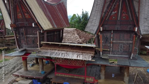 Preparation for the traditional death feast in Toraja or often referred to as Rambu Solo. You can see Tongkonan and Alang which are often used as a gathering place for large families photo