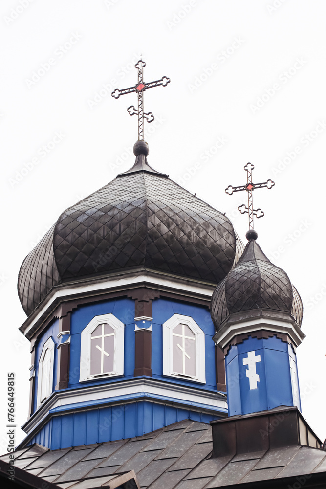 Orthodox church roof background. Metal domes with cross. Religious building architecture of Eastern Europe. Countryside village wooden church.