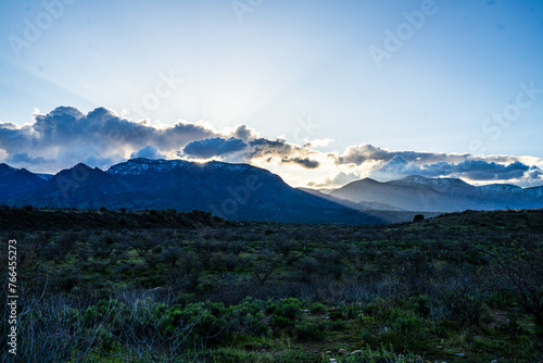 Sun rays and the snow-capped Mazatzal Mountains photo