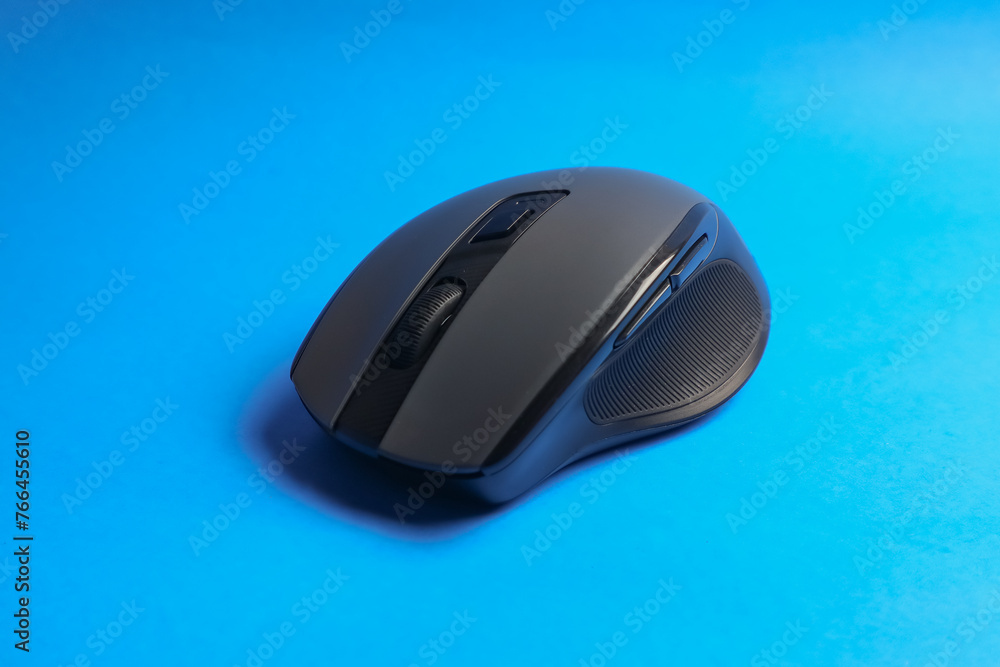 Modern wireless mouse with six buttons in blue background. Ergonomic mouse design. Gaming mouse Modern wireless mouse with six buttons in blue background. Ergonomic mouse design. Gaming mouse