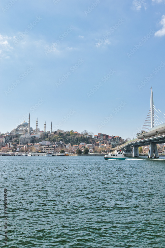 Istanbul, Turkey - March 23, 2024 - Beautiful view of the area of Eminönü in the Fatih district on the Golden Horn with Süleymaniye Mosque on a sunny day. This was on the first day of spring.