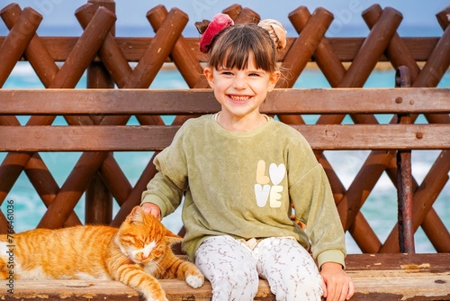 Portrait of a child with cat in cyprus on the beach 