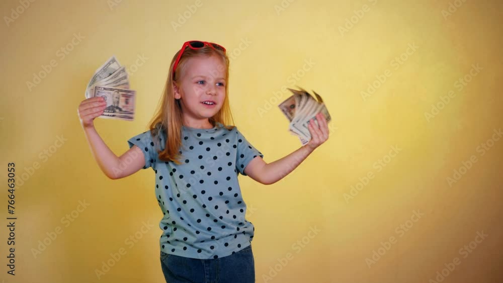 Child Cash Stack A little girl gleefully holding a handful of cash. Smiling child ...